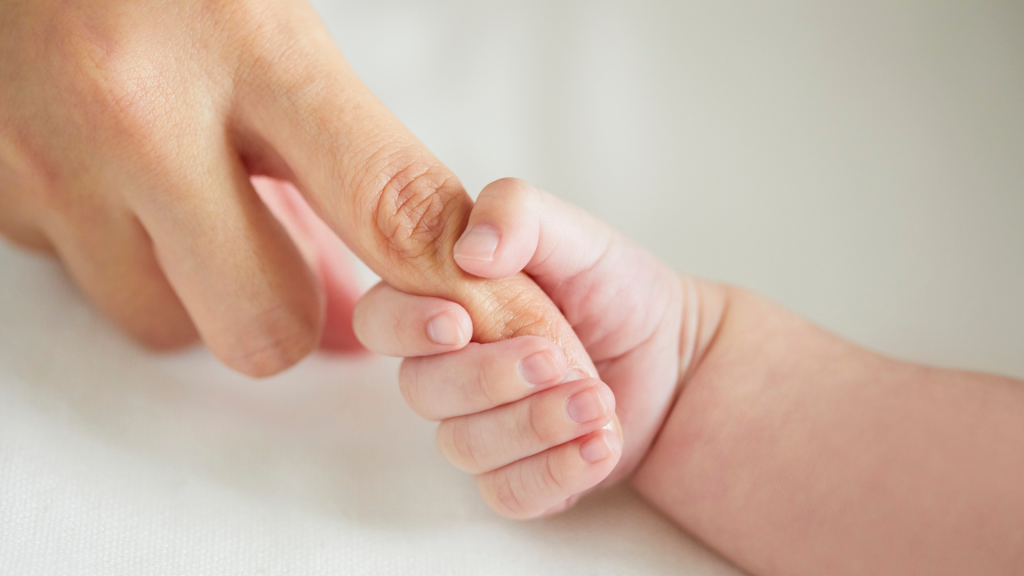 mãe segurando bebê durante salto de desenvolvimento